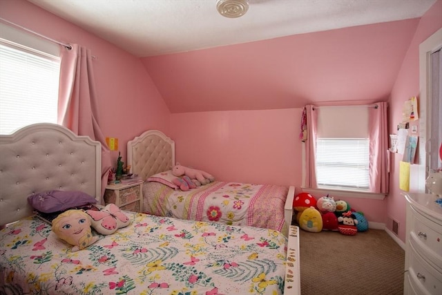 bedroom with vaulted ceiling, carpet, and multiple windows