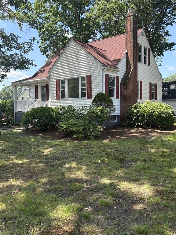 63 Bernice Ave, Brockton, MA 02301 - view of front of property with a chimney, a front lawn, and covered porch