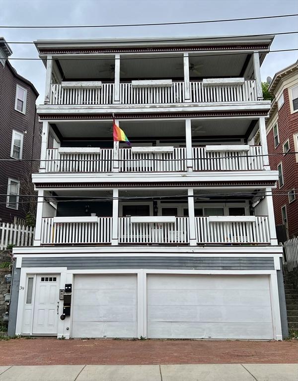 view of front of property with a garage and a balcony