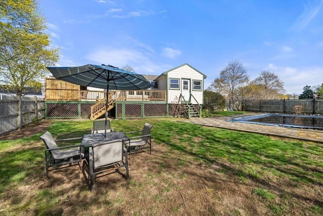 view of yard with stairway, a deck, and a fenced backyard