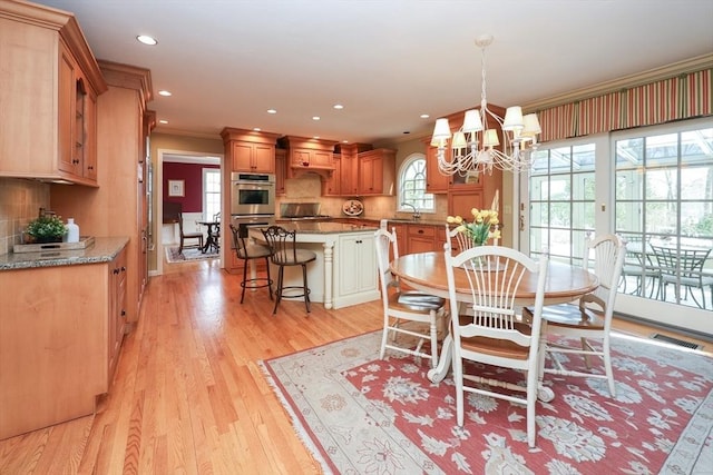 dining area with light wood finished floors, visible vents, crown molding, recessed lighting, and a notable chandelier