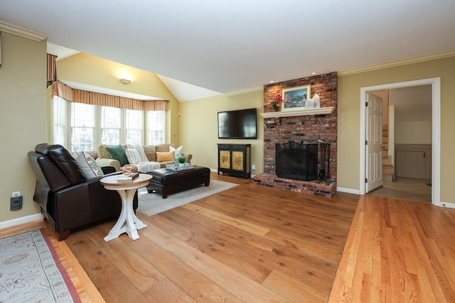 living area featuring baseboards, hardwood / wood-style floors, a fireplace, and vaulted ceiling