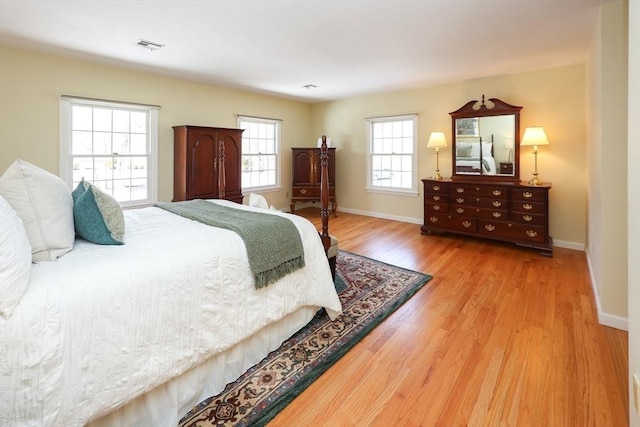 bedroom featuring visible vents, wood finished floors, and baseboards