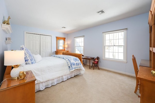 bedroom featuring visible vents, baseboards, a closet, and carpet flooring