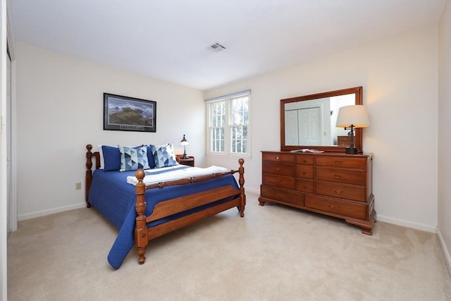 bedroom with light carpet, visible vents, and baseboards