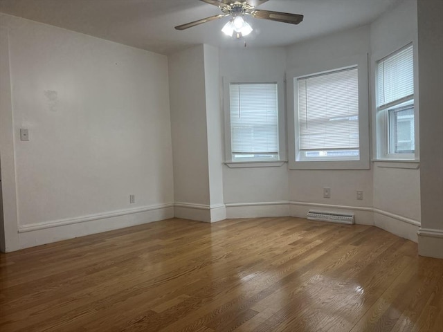 unfurnished room featuring visible vents, ceiling fan, baseboards, and wood finished floors