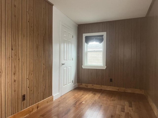 empty room with baseboards and wood finished floors