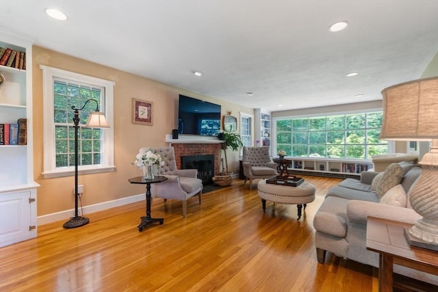 141 Morse Rd, Sudbury, MA 01776 - living area with a fireplace, light wood finished floors, and recessed lighting