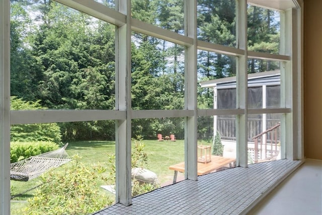 141 Morse Rd, Sudbury, MA 01776 - unfurnished sunroom featuring view of wooded area and healthy amount of natural light