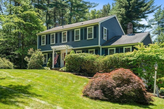 141 Morse Rd, Sudbury, MA 01776 - view of front facade with a chimney, a front yard, and a pergola