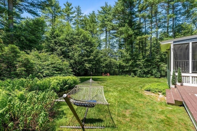 141 Morse Rd, Sudbury, MA 01776 - view of grassy yard featuring a wooden deck and a sunroom