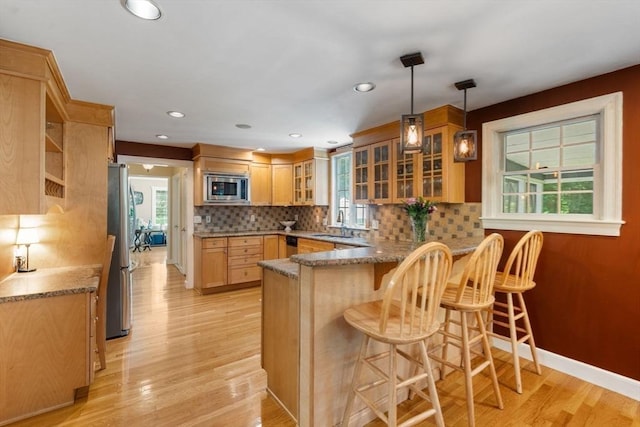 141 Morse Rd, Sudbury, MA 01776 - kitchen featuring stainless steel appliances, a peninsula, healthy amount of natural light, light wood-type flooring, and recessed lighting