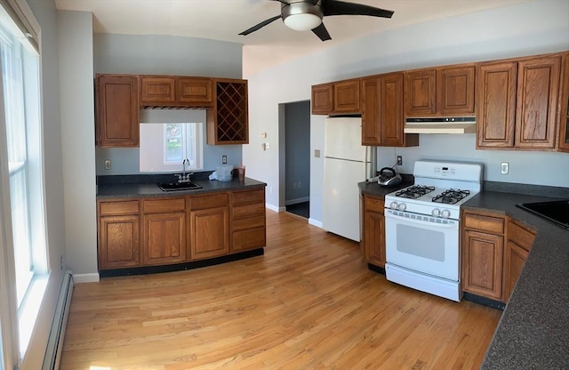 kitchen featuring sink, light wood-type flooring, baseboard heating, ceiling fan, and white appliances