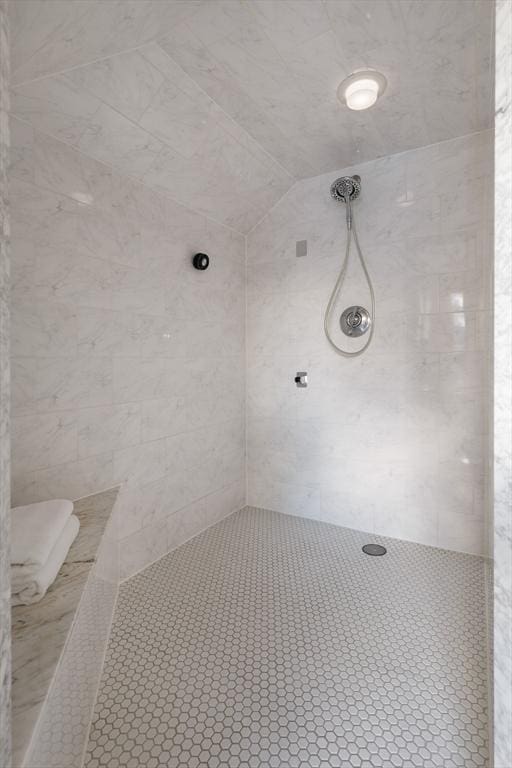 bathroom featuring a tile shower and tile patterned flooring