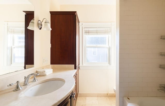 bathroom featuring tile patterned floors, vanity, toilet, and plenty of natural light