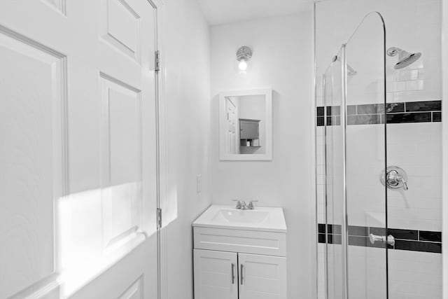 bathroom with vanity and a shower with shower door