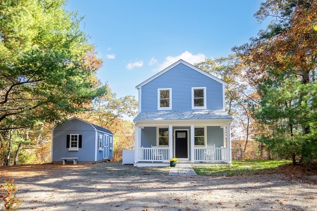 front facade featuring a shed and a porch