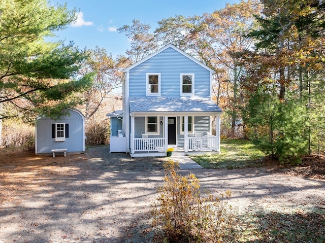 view of front property featuring a shed and a porch