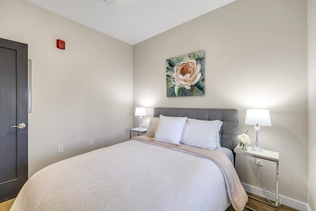 bedroom with hardwood / wood-style floors