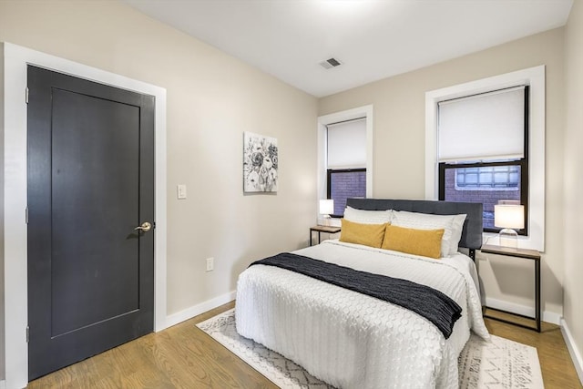 bedroom with hardwood / wood-style floors