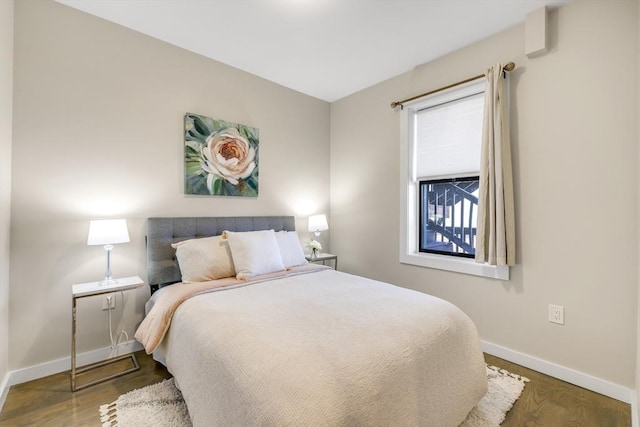 bedroom with dark hardwood / wood-style floors