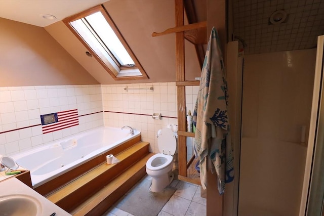 full bathroom with lofted ceiling with skylight, tile walls, tile patterned flooring, vanity, and toilet