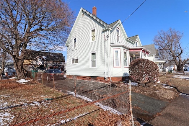 view of side of home with central AC unit