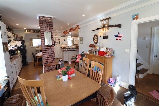 dining room featuring ornamental molding and dark hardwood / wood-style floors