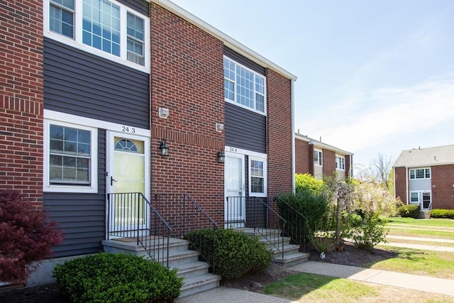 townhome / multi-family property with brick siding