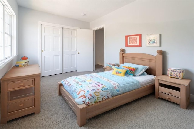 carpeted bedroom featuring a closet