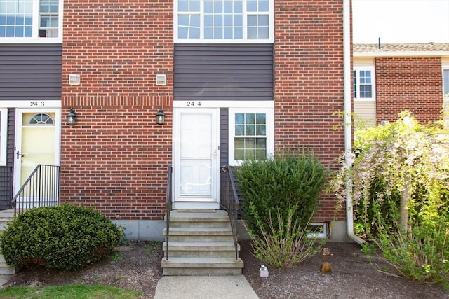 entrance to property featuring brick siding