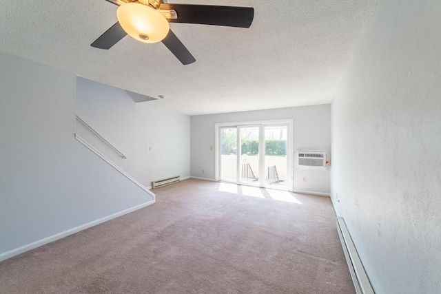 empty room with ceiling fan, a textured ceiling, a baseboard heating unit, and an AC wall unit