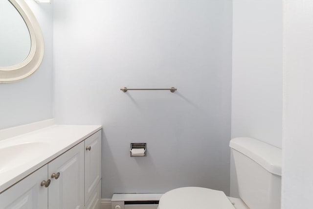 bathroom featuring a baseboard radiator, toilet, and vanity