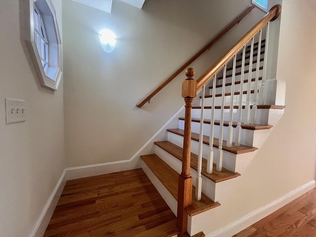 stairway with hardwood / wood-style floors