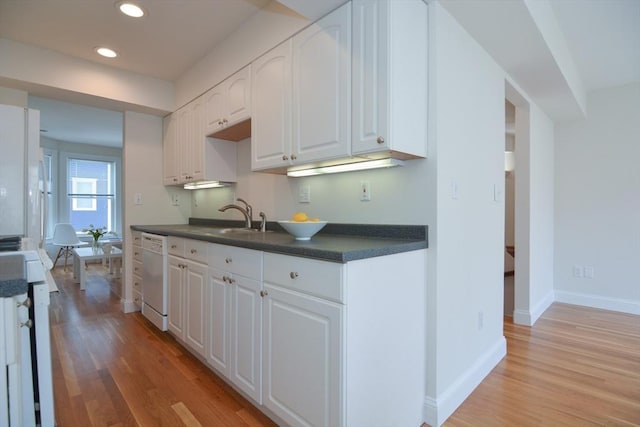 67 School St, Boston, MA 02129 - kitchen with white dishwasher, dark countertops, light wood finished floors, white cabinetry, and recessed lighting