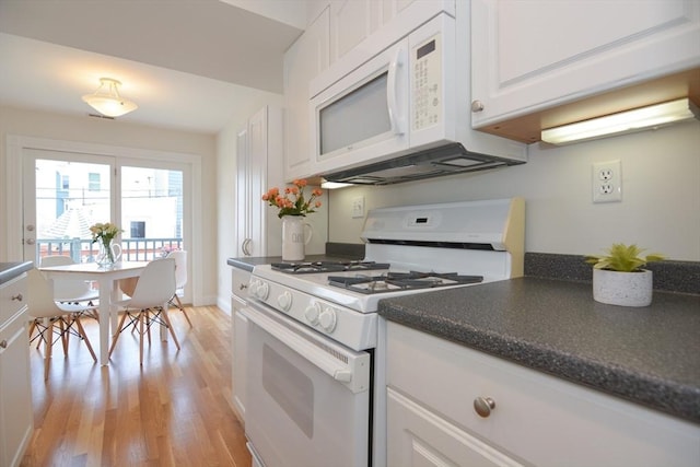 67 School St, Boston, MA 02129 - kitchen featuring white appliances, dark countertops, light wood finished floors, and white cabinetry