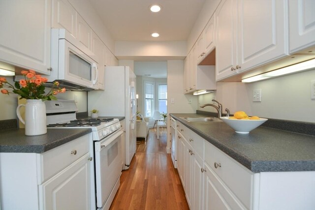 67 School St, Boston, MA 02129 - kitchen featuring white appliances, dark countertops, recessed lighting, light wood-style floors, and white cabinetry