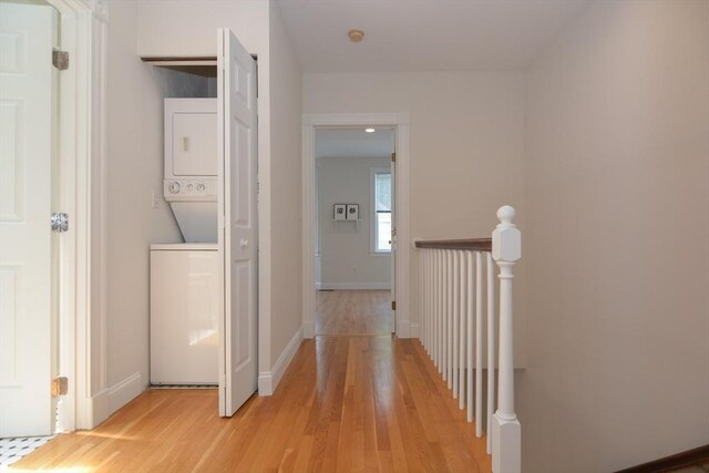 67 School St, Boston, MA 02129 - corridor with stacked washer / dryer, light wood-style flooring, and an upstairs landing