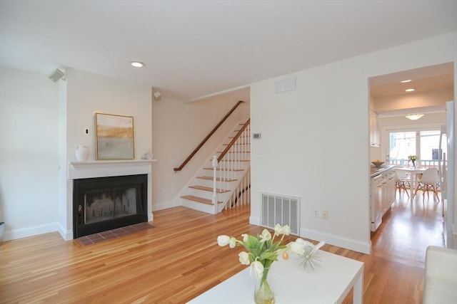 67 School St, Boston, MA 02129 - living area with light wood finished floors, stairs, a fireplace with flush hearth, and recessed lighting