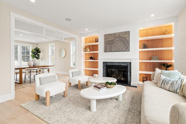 50 Hamilton Rd, Belmont, MA 02478 - living area with wood finished floors, baseboards, a fireplace, recessed lighting, and built in shelves