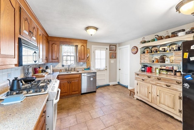 kitchen with sink, decorative backsplash, and black appliances