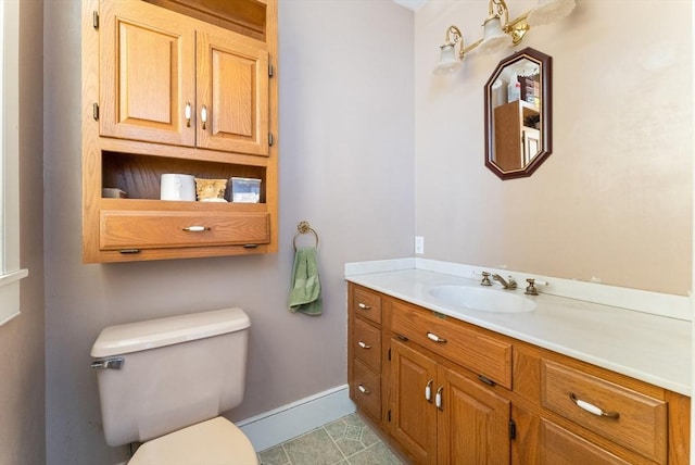 bathroom featuring tile patterned floors, vanity, and toilet