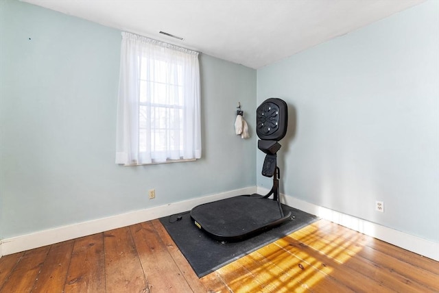 workout area featuring hardwood / wood-style flooring