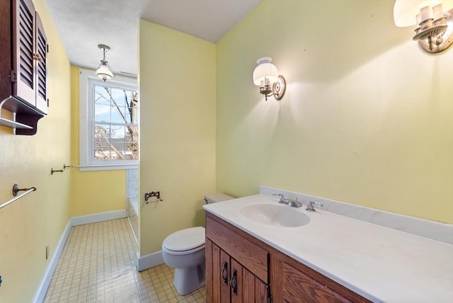 bathroom with vanity, toilet, and a bath