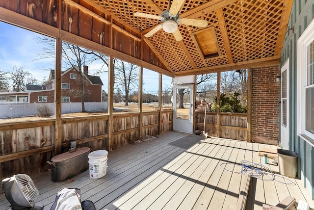 sunroom featuring ceiling fan, vaulted ceiling, and a wealth of natural light