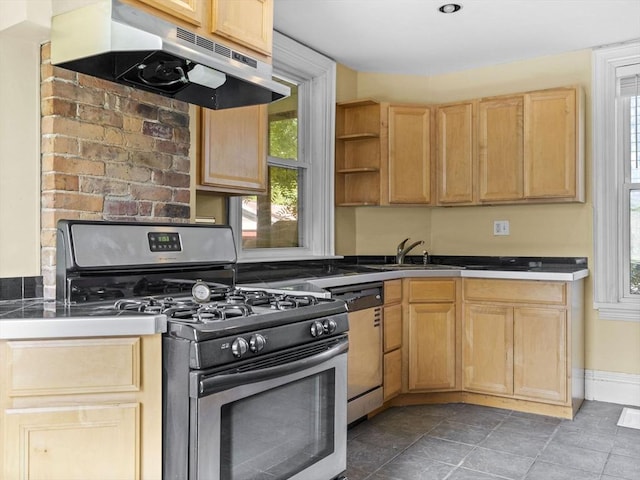 kitchen with stainless steel gas range oven, dishwasher, a healthy amount of sunlight, and light brown cabinetry