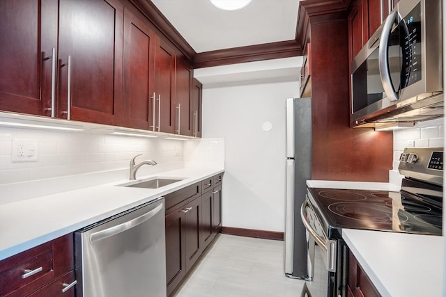 566 Commonwealth Ave Unit 906, Boston, MA 02215 - kitchen featuring appliances with stainless steel finishes, reddish brown cabinets, a sink, and tasteful backsplash