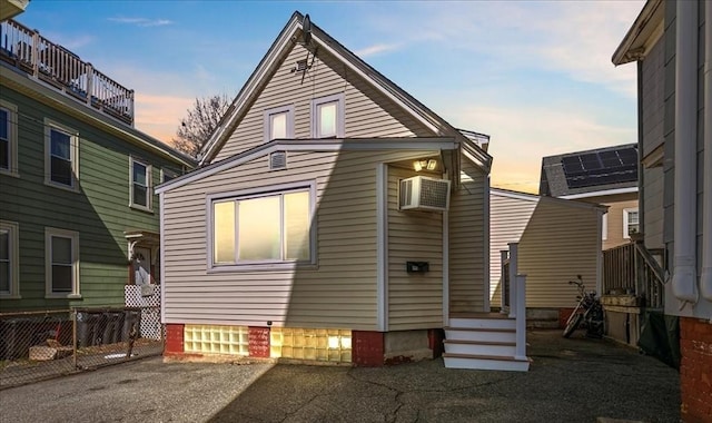 43 6th Ave, Haverhill, MA 01830 - back of property at dusk with fence and a wall mounted air conditioner