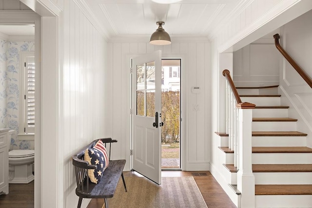 entryway with dark hardwood / wood-style flooring and ornamental molding