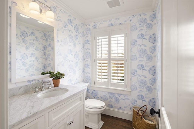 bathroom with vanity, hardwood / wood-style flooring, toilet, and ornamental molding